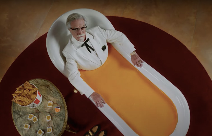 Coronel Sanders in a bathtub full of cheese
