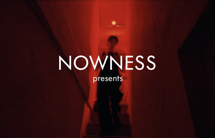 A woman going donwstairs in a red room
