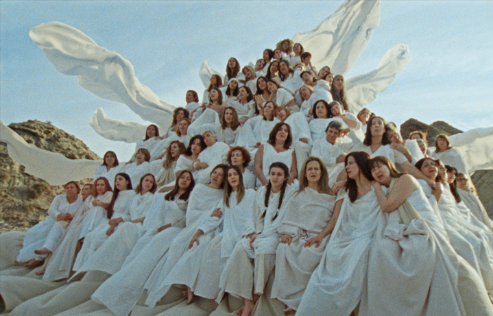 A piramid of women wearing white clothes